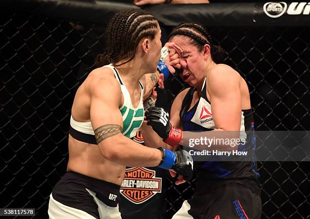 Jessica Andrade lands a left to the face of Jessica Penne in their women's strawweight bout during the UFC 199 event at The Forum on June 4, 2016 in...