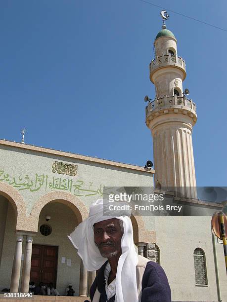 muslim man outside asmara mosque - asmara eritrea stock pictures, royalty-free photos & images