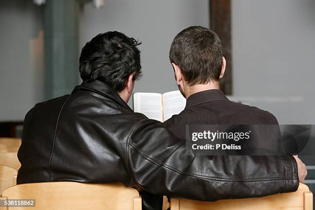 gay couple in church - catholicism stockfoto's en -beelden