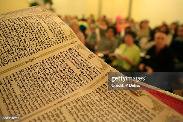 book of esther at purim celebration - purim stock pictures, royalty-free photos & images