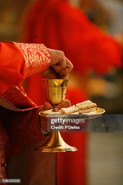 melchite priest celebrating mass - communion bread stock pictures, royalty-free photos & images