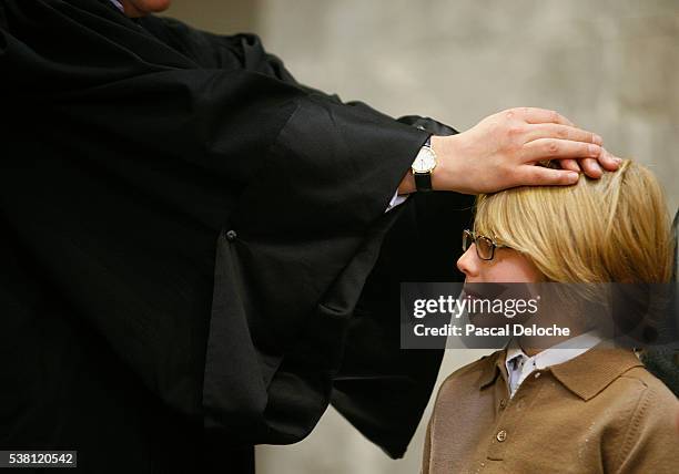 boy being baptized at a reform church in france - padre imagens e fotografias de stock