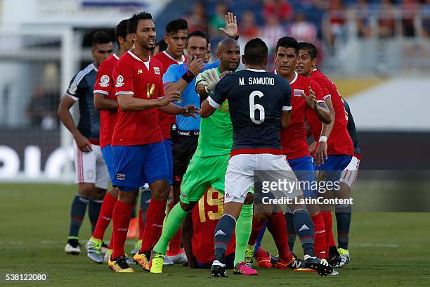 Miguel Samudio of Paraguay clashes with players of Costa Rica at midfield after an injury during a group A match between Costa Rica and Paraguay at...