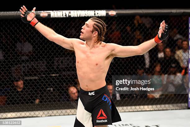 Brian Ortega celebrates after his TKO in the third round against Clay Guida in their featherweight bout during the UFC 199 event at The Forum on June...
