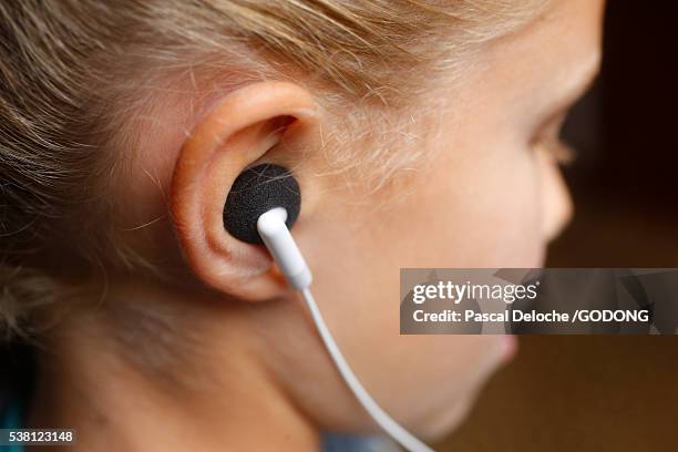 young girl with ipod - in ear headphones stock-fotos und bilder