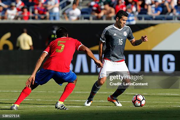 Celso Ortiz of Paraguay passes against Celso Borges of Costa Rica during a group A match between Costa Rica and Paraguay at Camping World Stadium l...