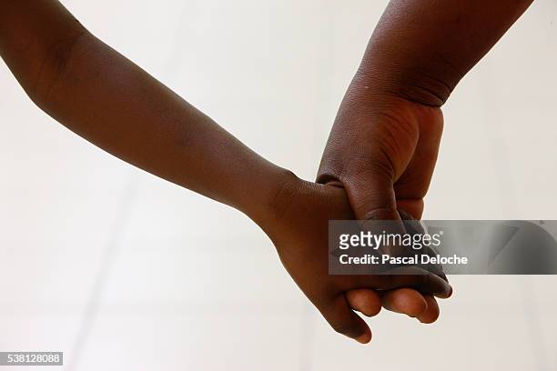 child holding an adult hand - port au prince stock pictures, royalty-free photos & images