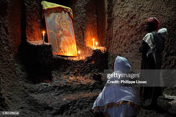 women praying in bet medhane alem church in lalibela - coptic christians stockfoto's en -beelden