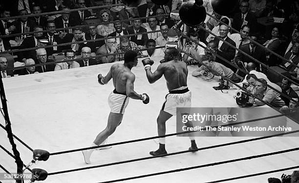 Cassius Clay moves to land a punch against Sonny Liston at the Convention Center in Miami Beach, Florida, February 25, 1964. Cassius Clay won the...