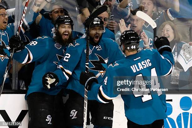 Joel Ward of the San Jose Sharks celebrates his goal with Brent Burns and Marc-Edouard Vlasic against the Pittsburgh Penguins during the third period...