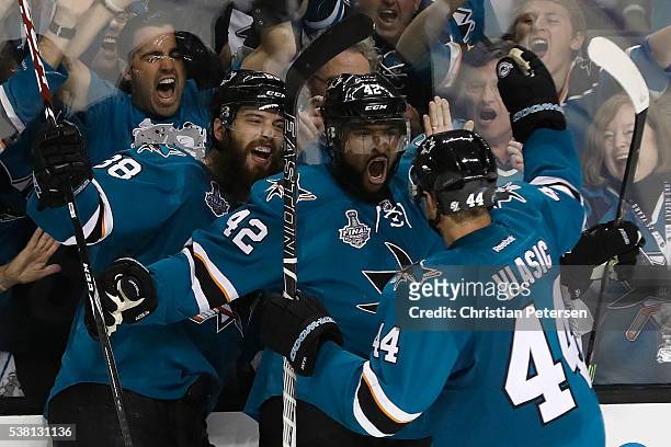 Joel Ward of the San Jose Sharks celebrates his goal with Brent Burns and Marc-Edouard Vlasic against the Pittsburgh Penguins during the third period...