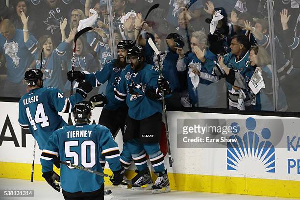 Joel Ward of the San Jose Sharks celebrates his goal with Brent Burns, Marc-Edouard Vlasic and Chris Tierney against the Pittsburgh Penguins during...