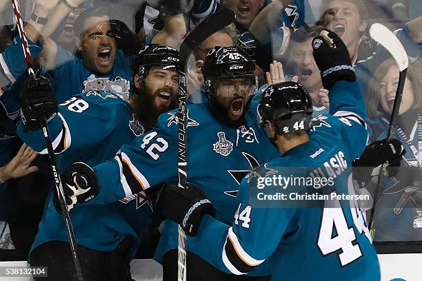 Joel Ward of the San Jose Sharks celebrates with his teammates after scoring a goal against the Pittsburgh Penguins during the third period in Game...