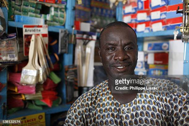 galaye diagne runs a hardware store financed by loans from a microcredit institution - senegal man stock pictures, royalty-free photos & images