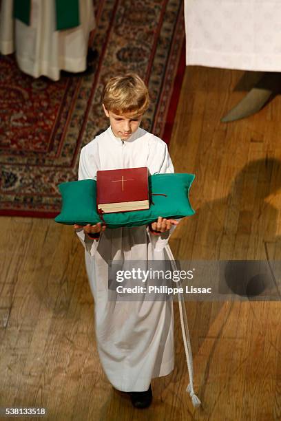 altar boy carrying a bible during mass - altar boy stock pictures, royalty-free photos & images