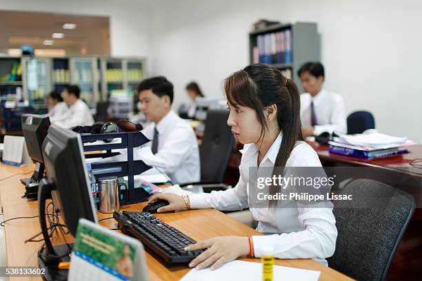 employees at work in hkl microfinance head office - cambodian ethnicity stock pictures, royalty-free photos & images