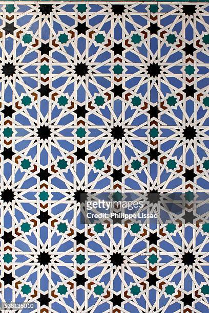 real alcazar de sevilla - mosaic azulejo decoration in the patio de las doncellas - islam ornament stock pictures, royalty-free photos & images