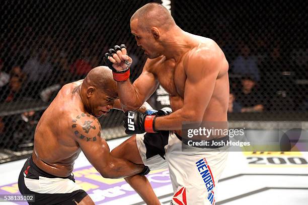 Dan Henderson and Hector Lombard of Cuba exchange blows in their middleweight bout during the UFC 199 event at The Forum on June 4, 2016 in...