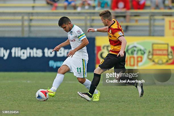 Andres Flores of the New York Cosmos brings the ball upfield past Manny Gonzalez of the Fort Lauderdale Strikers on June 4, 2016 at Lockhart Stadium...