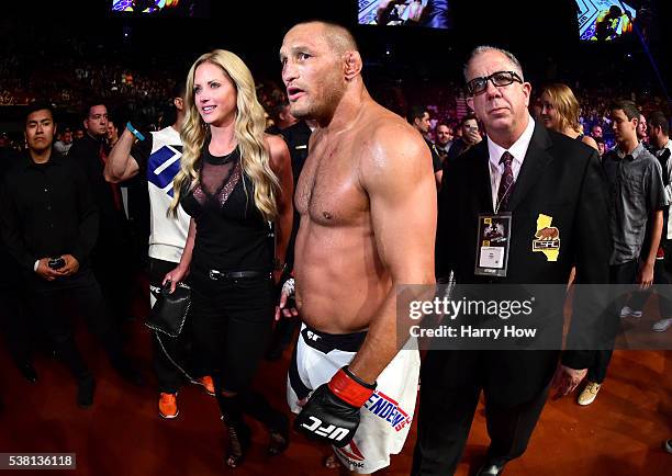 Dan Henderson walks with his wife from the Octagon after defeating Hector Lombard in their middleweight bout during the UFC 199 event at The Forum on...