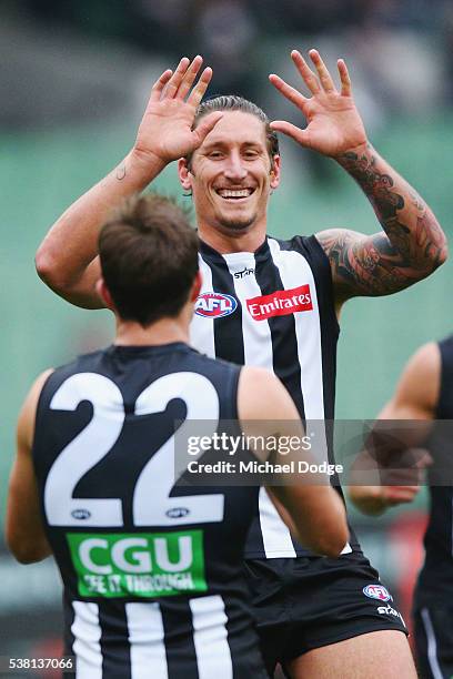 Jesse White of the Magpies celebrates a goal with Steele Sidebottom during the round 11 AFL match between the Collingwood Magpies and the Port...