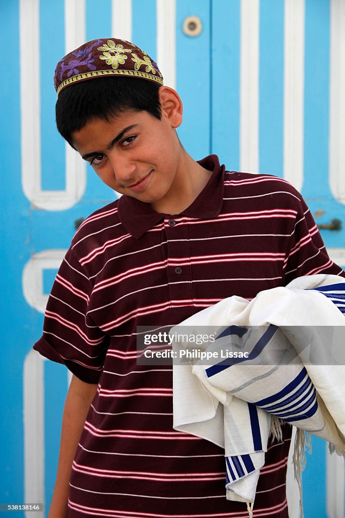 Jewish boy carrying his prayer shawl