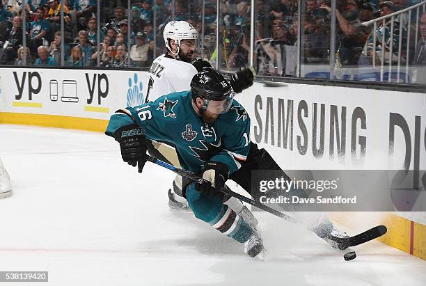 Nick Spaling of the San Jose Sharks wins the puck from Justin Schultz of the Pittsburgh Penguins in the end boards during the first overtime of Game...