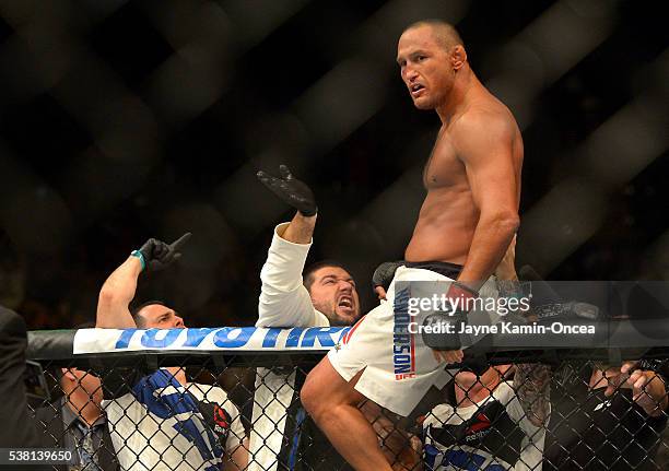 Dan Henderson climbs the cage after winning his middleweight bout at UFC 199 at The Forum on June 4, 2016 in Inglewood, California.