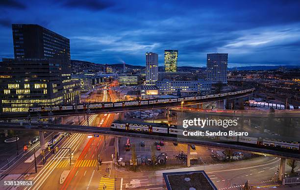 zürich cityscape at night with trains passing - tram zürich stock pictures, royalty-free photos & images