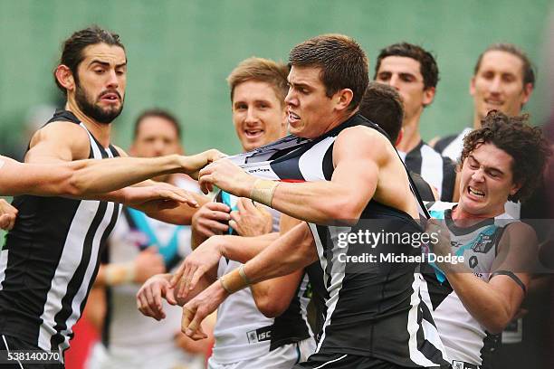 Mason Cox of the Magpies is scragged after starting a melee during the round 11 AFL match between the Collingwood Magpies and the Port Adelaide Power...