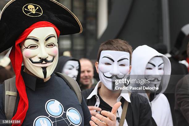 protesters wearing guy fawkes masks , trademark of the anonymous movement and based on a character in the film v for vendetta. - guy fawkes mask stock pictures, royalty-free photos & images