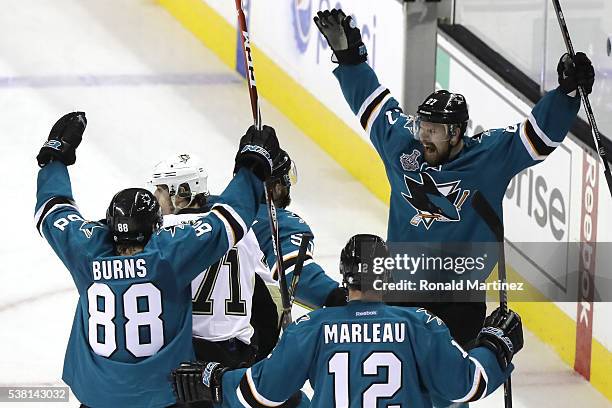 Joonas Donskoi of the San Jose Sharks celebrates his game winning goal with Chris Tierney, Brent Burns and Patrick Marleau in front of Evgeni Malkin...