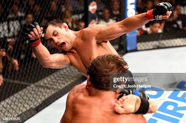 Dominick Cruz kicks Urijah Faber in their UFC bantamweight championship bout during the UFC 199 event at The Forum on June 4, 2016 in Inglewood,...