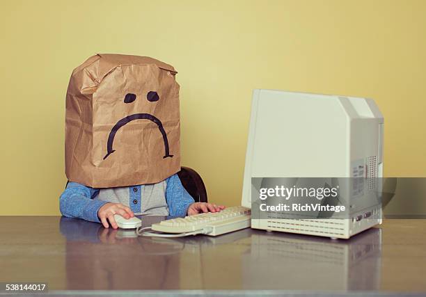 young boy in front of computer is cyber bullying victim - bullying workplace stock pictures, royalty-free photos & images