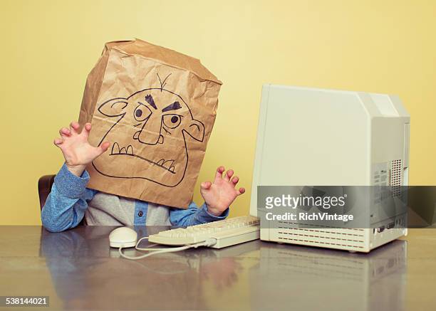 internet troll is mean at the computer - rich fury stock pictures, royalty-free photos & images