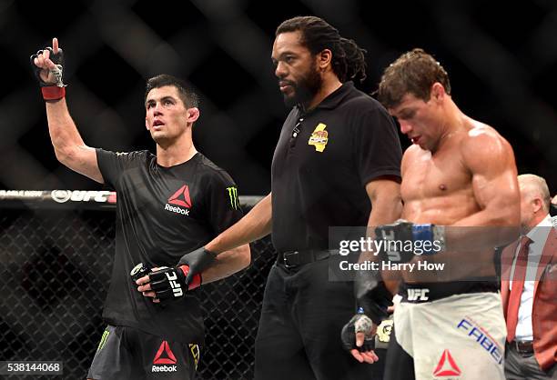 Dominick Cruz celebrates after defeating Urijah Faber by unanimous decision in their UFC bantamweight championship bout during the UFC 199 event at...