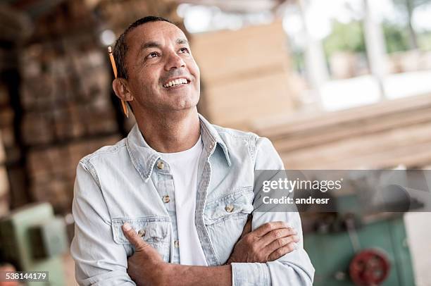 man at a carpentry looking thoughtful - hispanic construction worker stock pictures, royalty-free photos & images