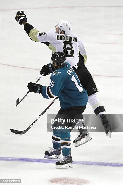 Brian Dumoulin of the Pittsburgh Penguins jumps for the puck in front of Nick Spaling of the San Jose Sharks during overtime in Game Three of the...