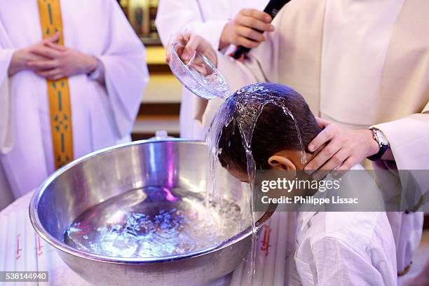 baptism in st jacques's catholic church - baptism stock pictures, royalty-free photos & images