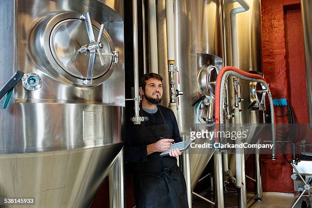 brewmaster checking his brew - brewmaster stockfoto's en -beelden
