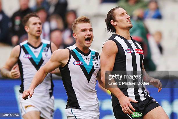 Ollie Wines of the Power reacts after Jesse White of the Magpies misses an easy kick for goal during the round 11 AFL match between the Collingwood...