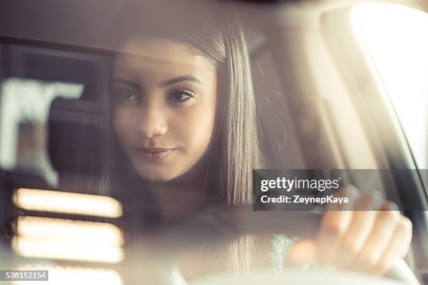 young happy woman driving - comfortable car stock pictures, royalty-free photos & images