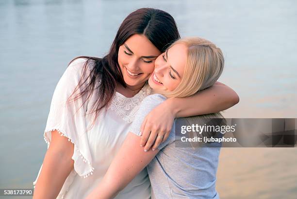 affectionate friends embracing each other, women hugs - baby number 2 stock pictures, royalty-free photos & images