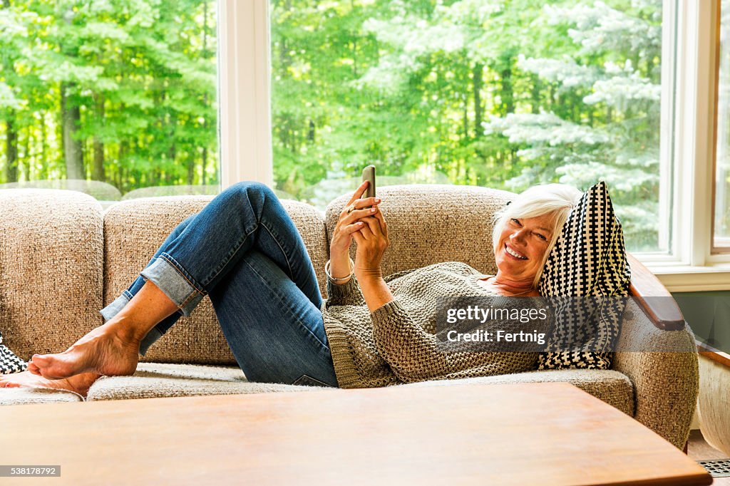 Happy smiling mature woman with a smartphone