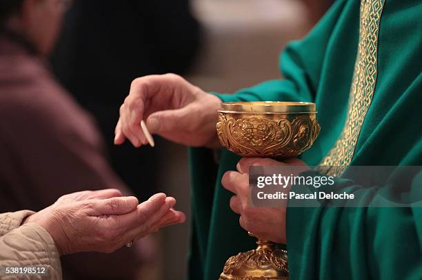 st. louis's church. mass. holy communion. - catholic priest stock pictures, royalty-free photos & images