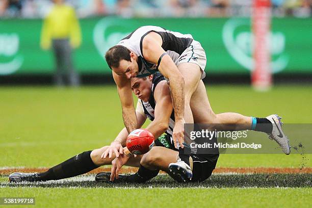 Mason Cox of the Magpies and Matthew Broadbent of the Power compete for the ball during the round 11 AFL match between the Collingwood Magpies and...