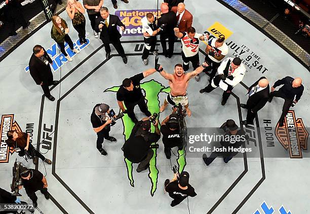 Michael Bisping of England celebrates after his first round knockout win against Luke Rockhold in their UFC middleweight championship bout during the...