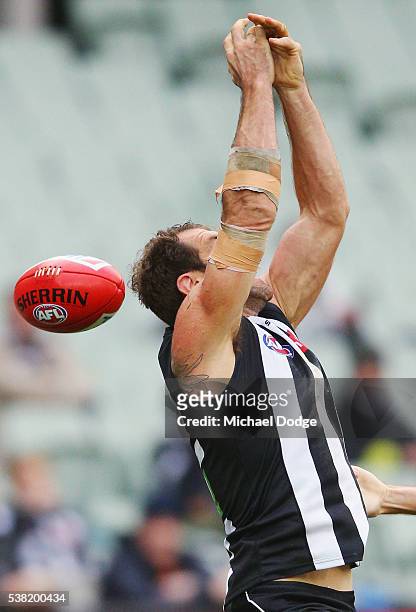 Travis Cloke of the Magpies fumbles a mark during the round 11 AFL match between the Collingwood Magpies and the Port Adelaide Power at Melbourne...