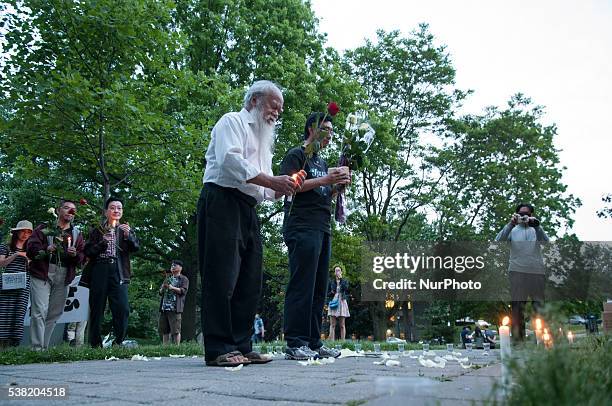 Members of the Toronto Association for Democracy in China, lights the candle in front of the Chinese embassy 4 June 2016 to commemorate the 27th...