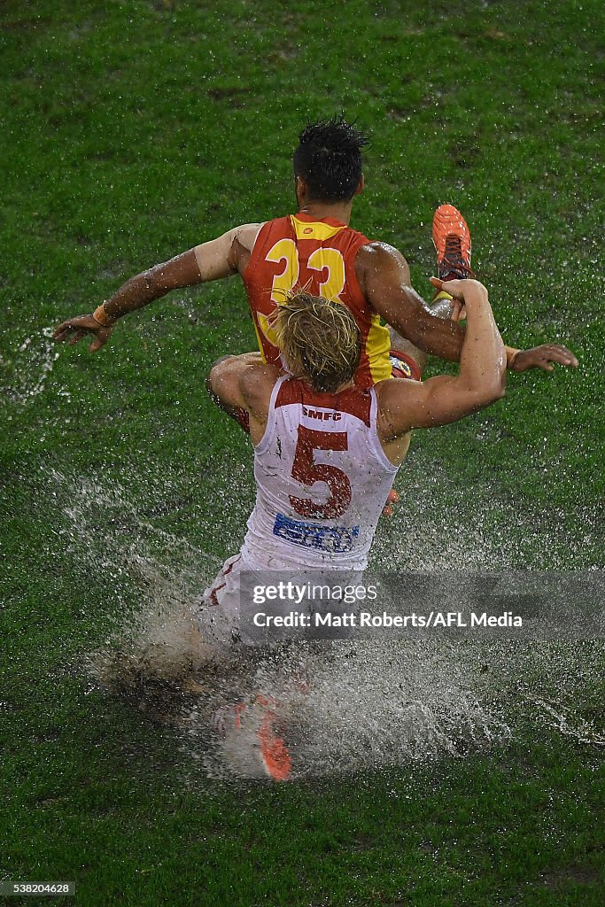 Aaron Hall Of The Suns Is Tackled By Isaac Heeney Of The Swans During... News Photo - Getty Images